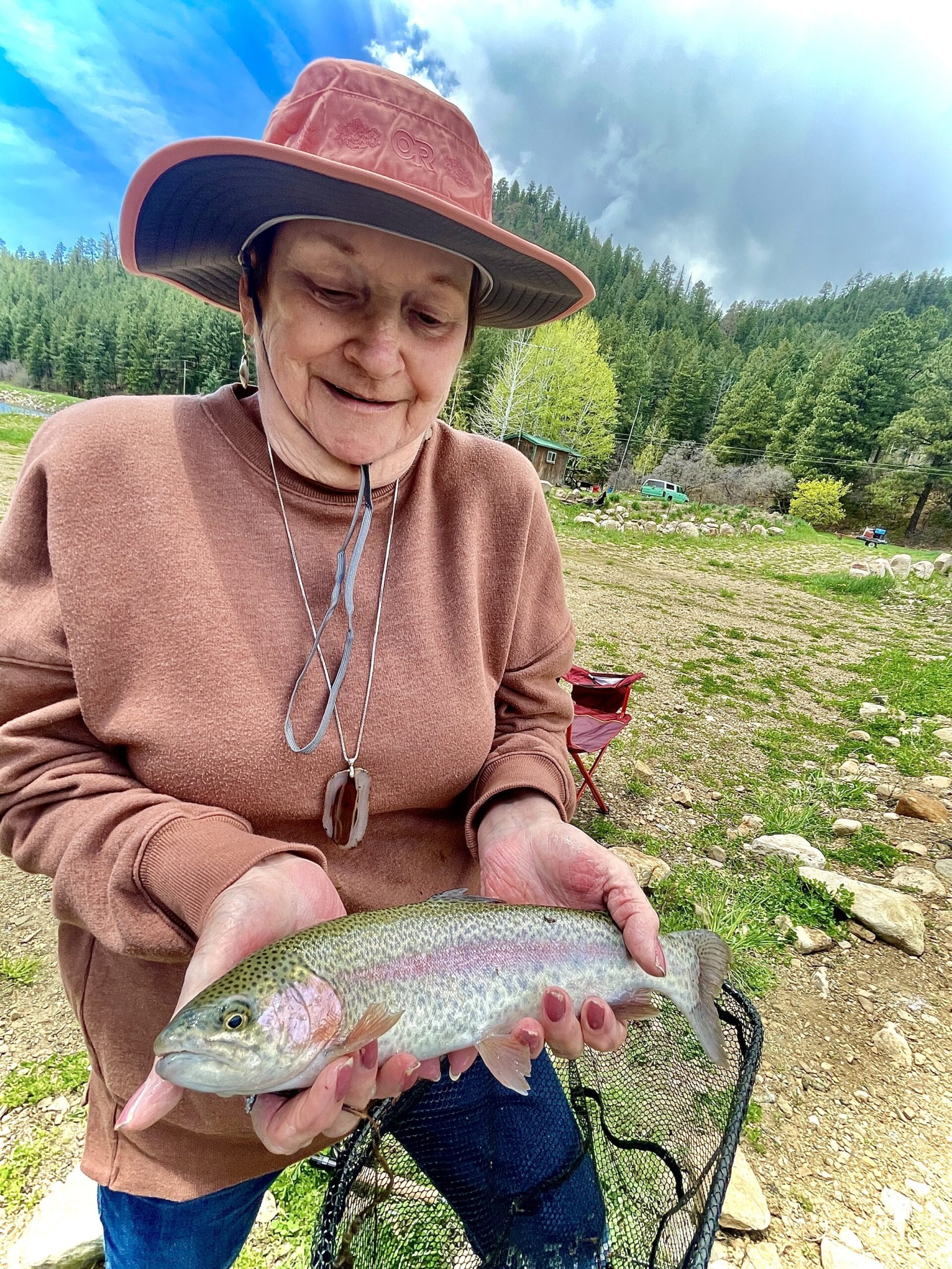 Customer showing off a great catch — Ski & Bow Rack Wall O' Fish