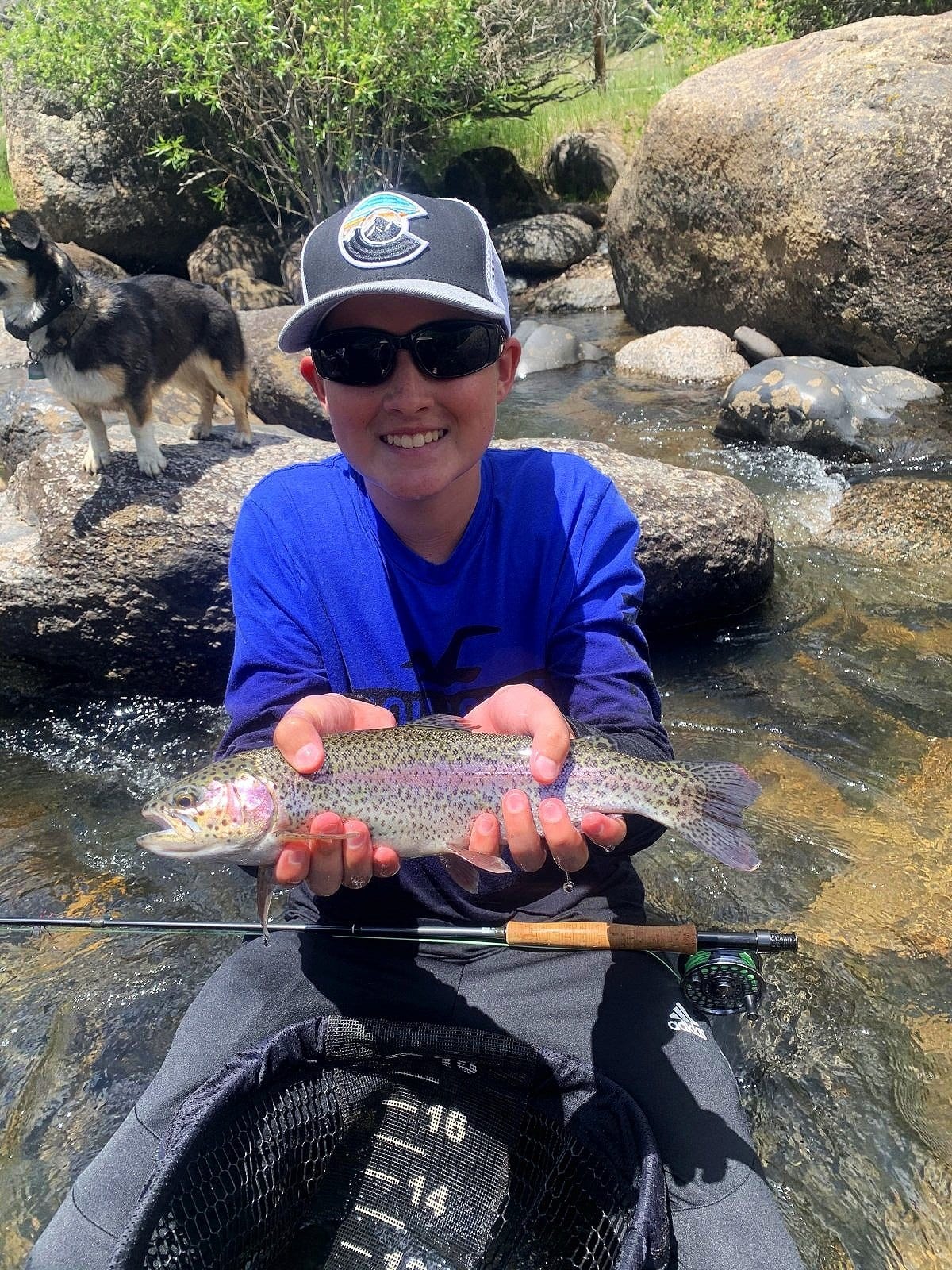 Kid catching rainbow trout on family guided fly fishing trip Pagosa Springs Colorado