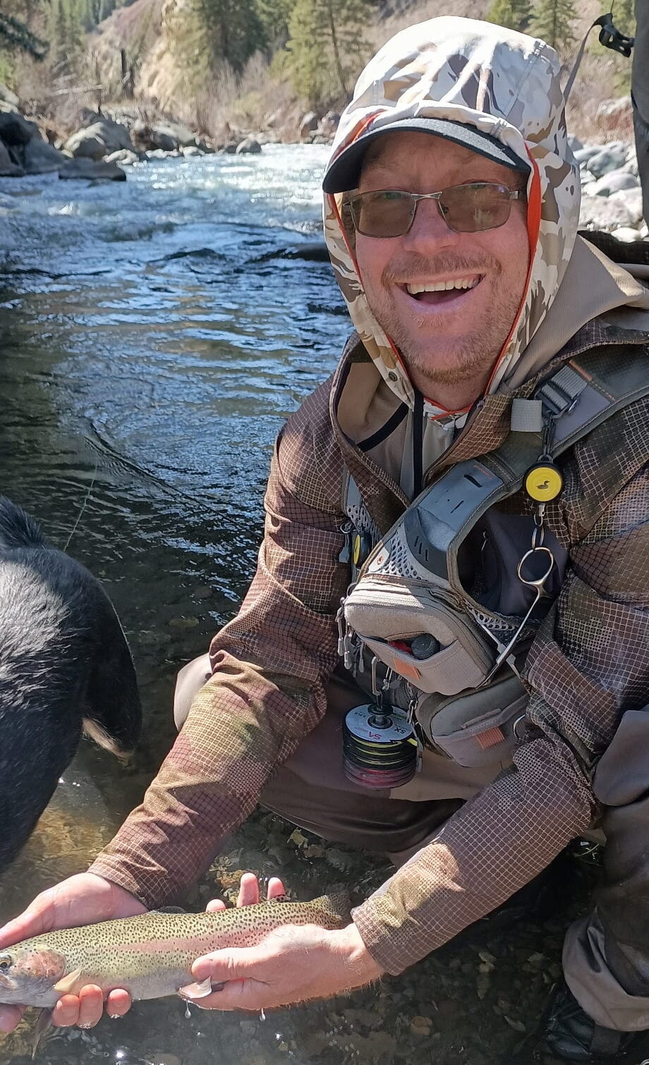 Angler holding a trophy rainbow trout on the upper San Juan River at Weber Ranch