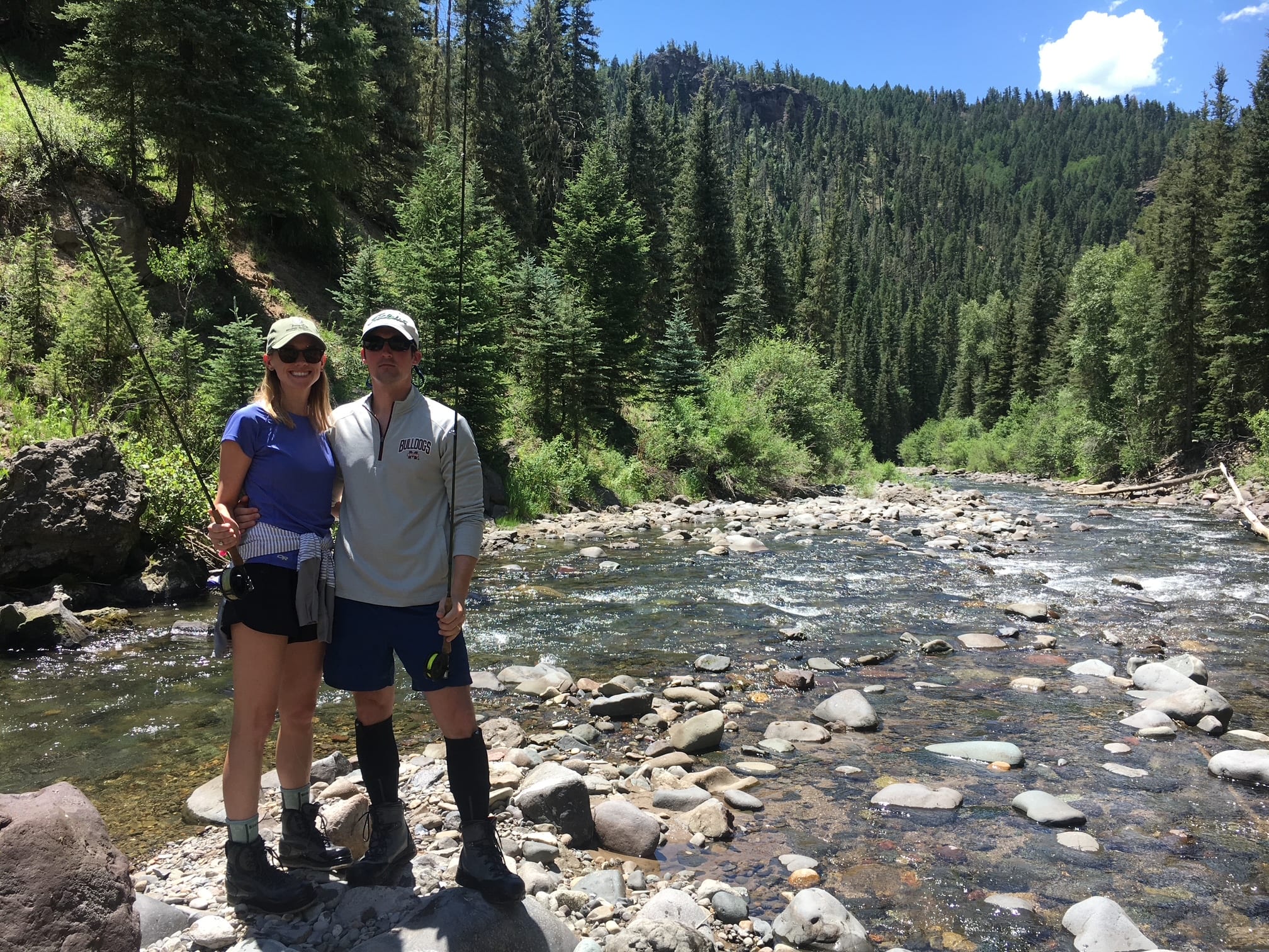 Couple on a guided fly fishing trip on a mountain river near Pagosa Springs Colorado