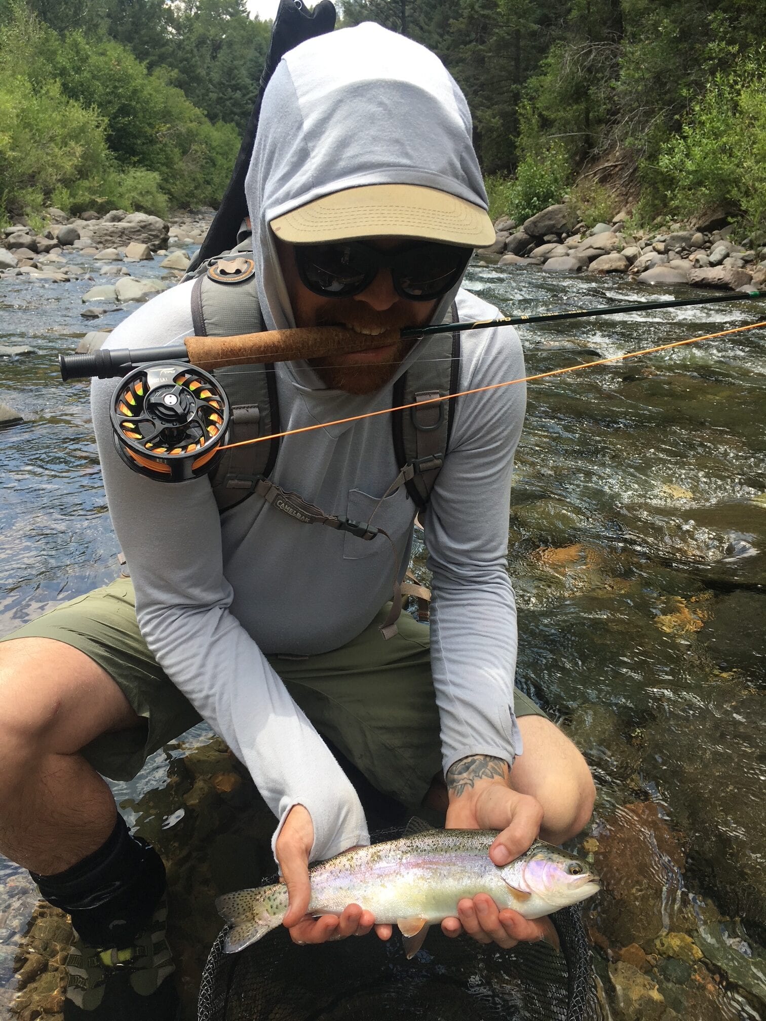 Fly fishing guide holding a rainbow trout on the San Juan River