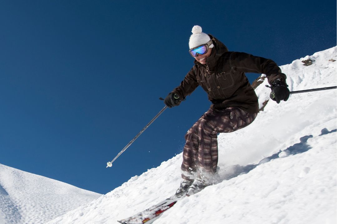 Skier on the groomed runs at Wolf Creek Ski Area with Ski & Bow Rack demo skis